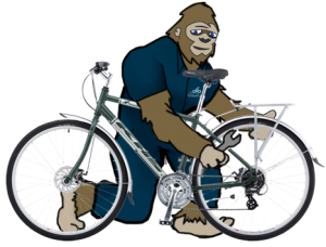 The Missing Link Sasquatch mascot working on a bike
